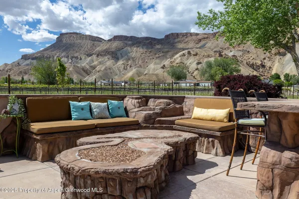 a terrace with outdoor seating and city view