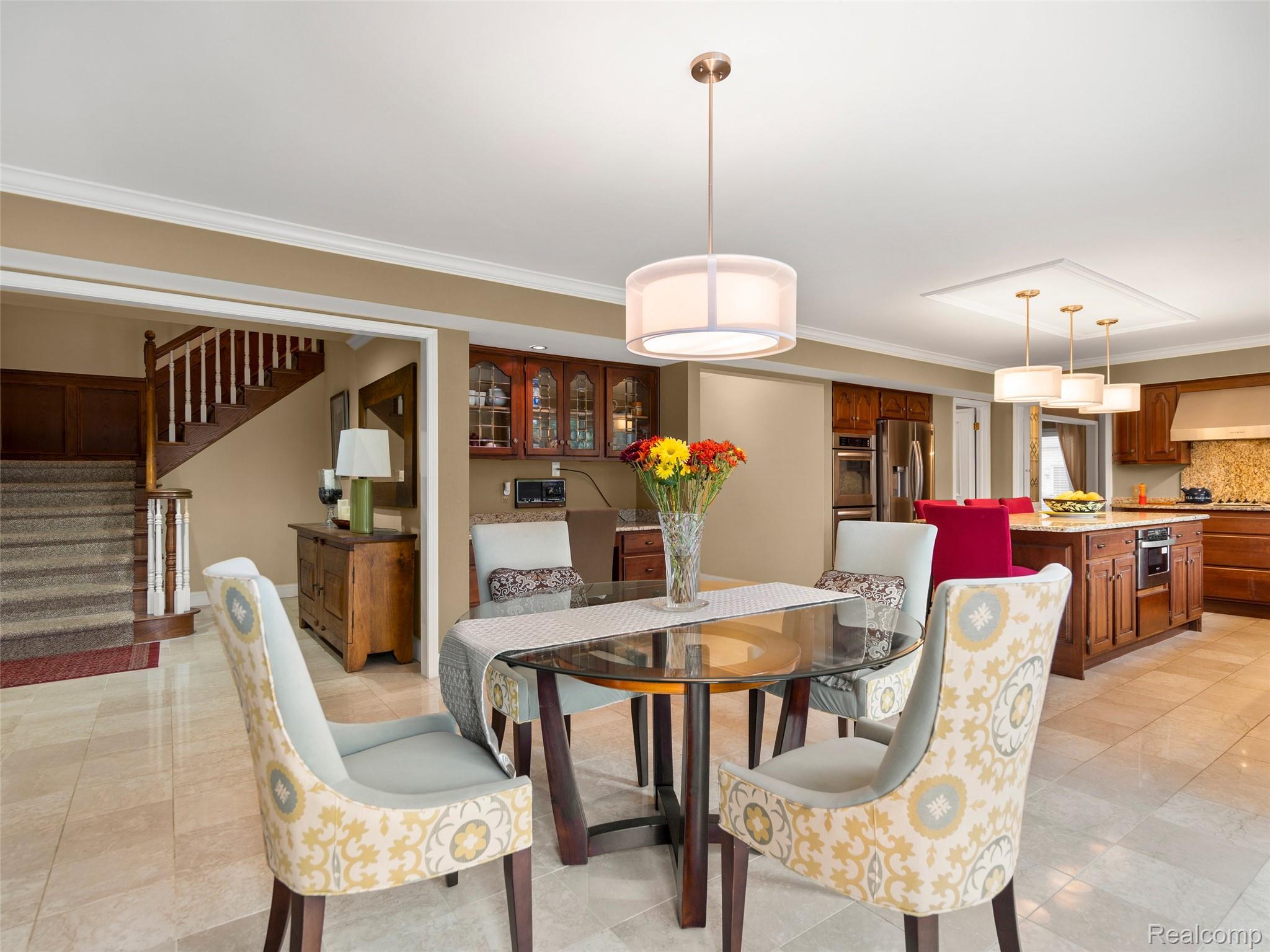 5724 Murfield Drive Rochester, MI 48306 - Photo 55 of 99 Dining space with crown molding, stairway, and light tile patterned flooring