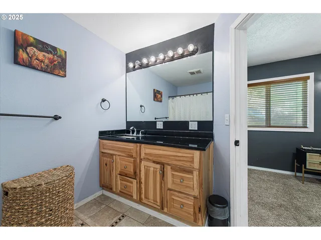 a bathroom with a sink a vanity and a mirror