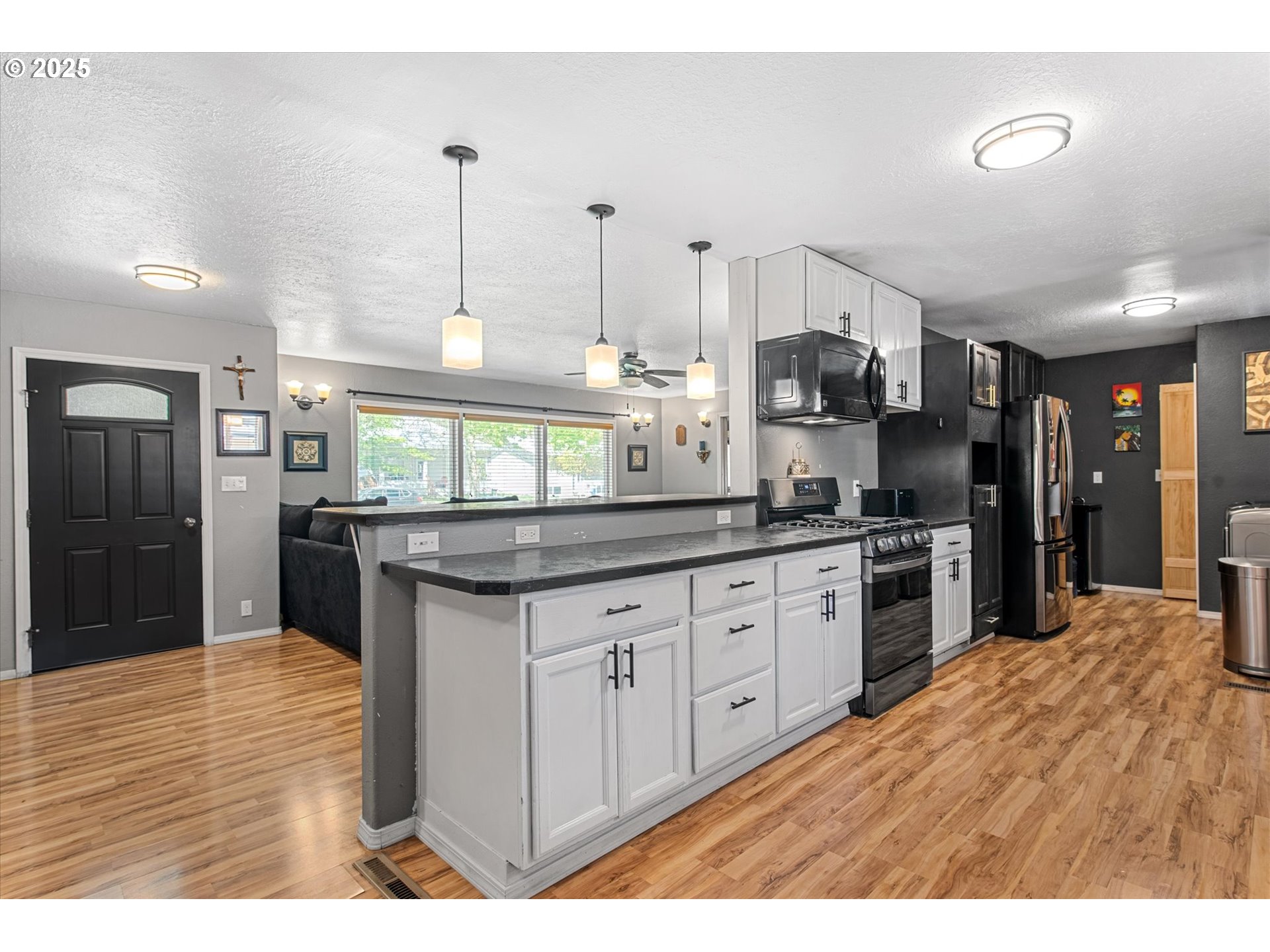 1701 Walnut Street La Grande, OR 97850 - Photo 10 of 22 a kitchen with granite countertop a stove a sink and a refrigerator