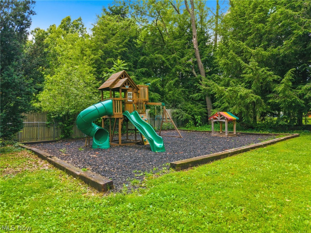 4449 18th Street Northwest Canton, OH 44708 - Photo 25 of 25 Expansive backyard recreation area featuring a wood playset with two slides, a swing set, and a separate small play structure