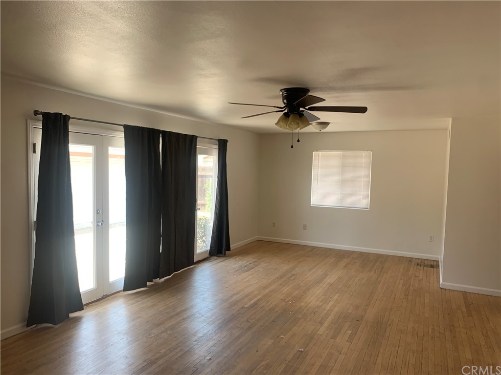 4667 Wellesley Way Riverside, CA 92507 - Photo 2 of 8 a view of an empty room with wooden floor and a window