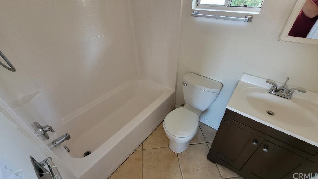 4667 Wellesley Way Riverside, CA 92507 - Photo 8 of 8 a white toilet sitting next to a bath tub