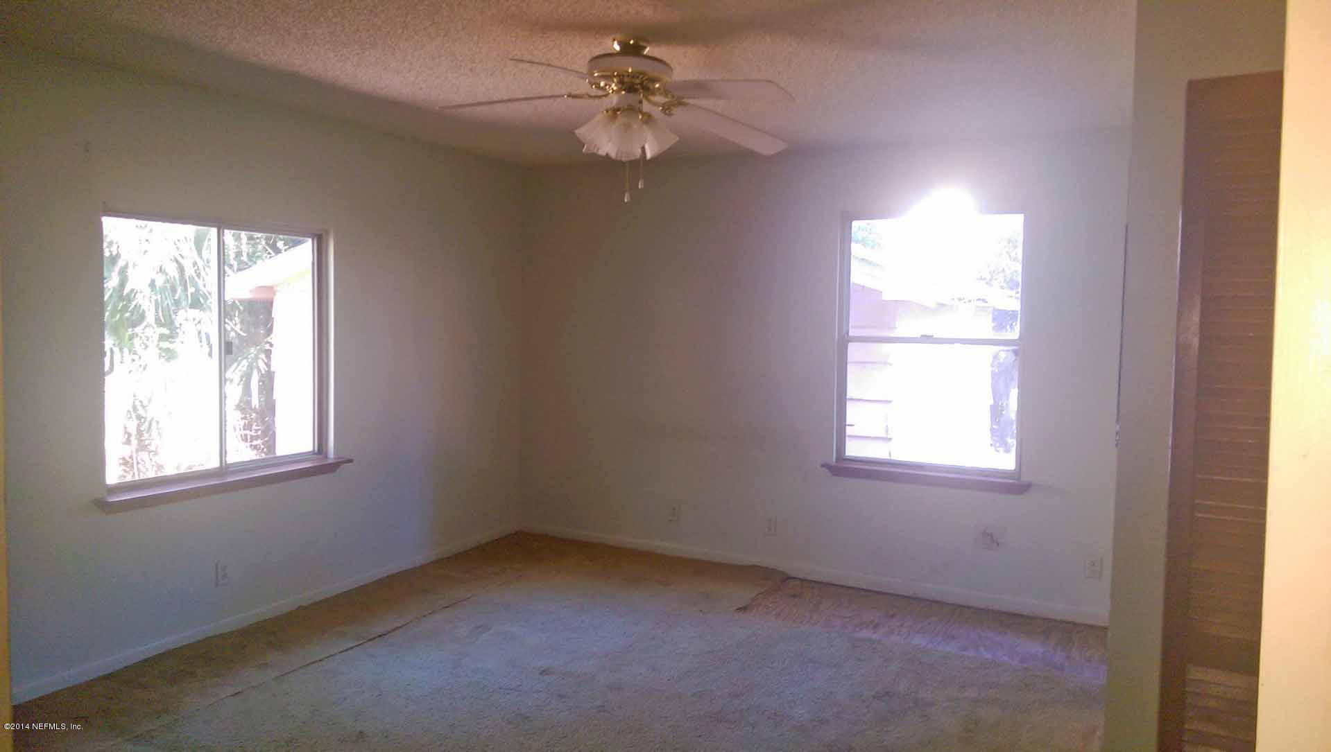 1795 Lilly Road East Jacksonville, FL 32207 - Photo 6 of 12 an empty room with windows and fan