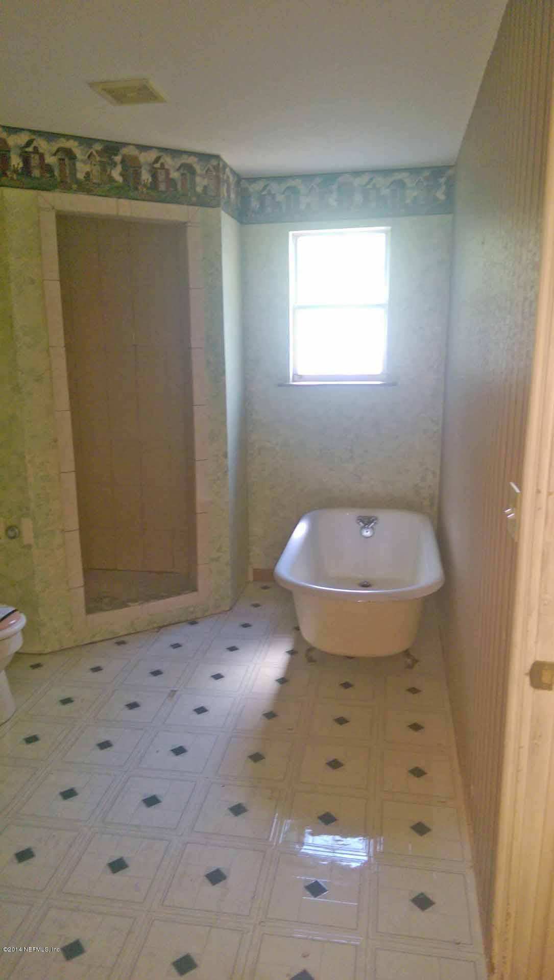 1795 Lilly Road East Jacksonville, FL 32207 - Photo 8 of 12 a bathroom with a sink and a mirror