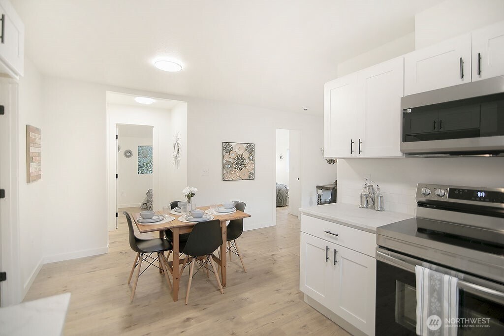 251 Swofford Road Mossyrock, WA 98564 - Photo 12 of 38 a view of kitchen with sink dining table and chairs