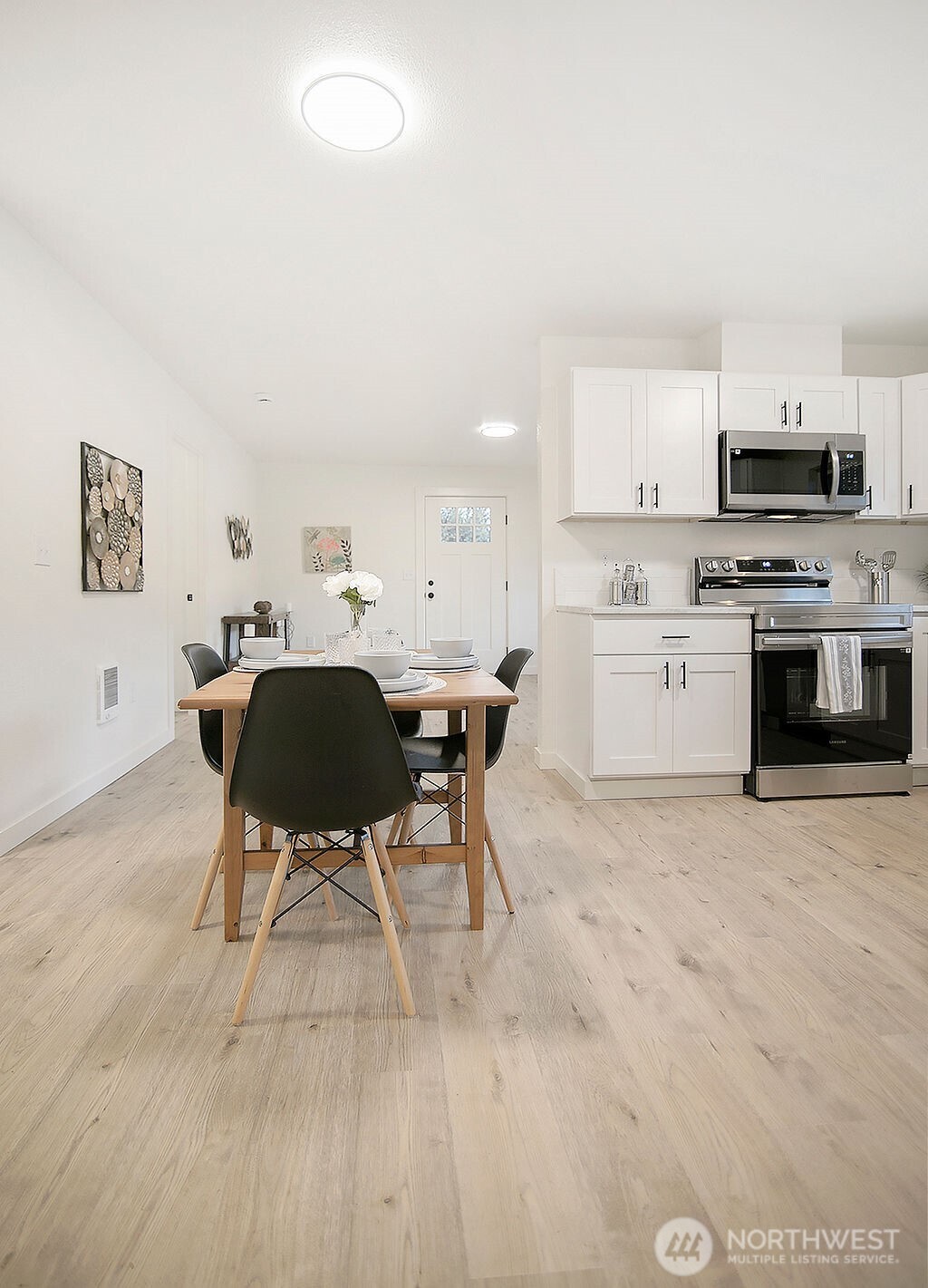 251 Swofford Road Mossyrock, WA 98564 - Photo 16 of 38 a open kitchen with stainless steel appliances granite countertop a stove top oven a sink a dining table and chairs with wooden floor