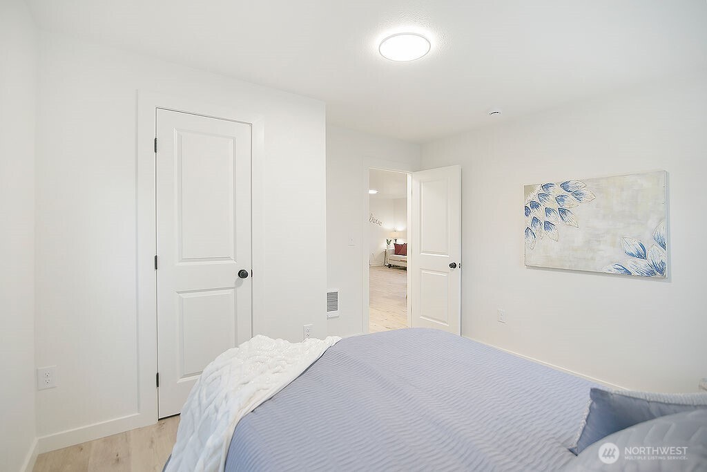 251 Swofford Road Mossyrock, WA 98564 - Photo 20 of 38 a bedroom with a bed and a painting on the wall