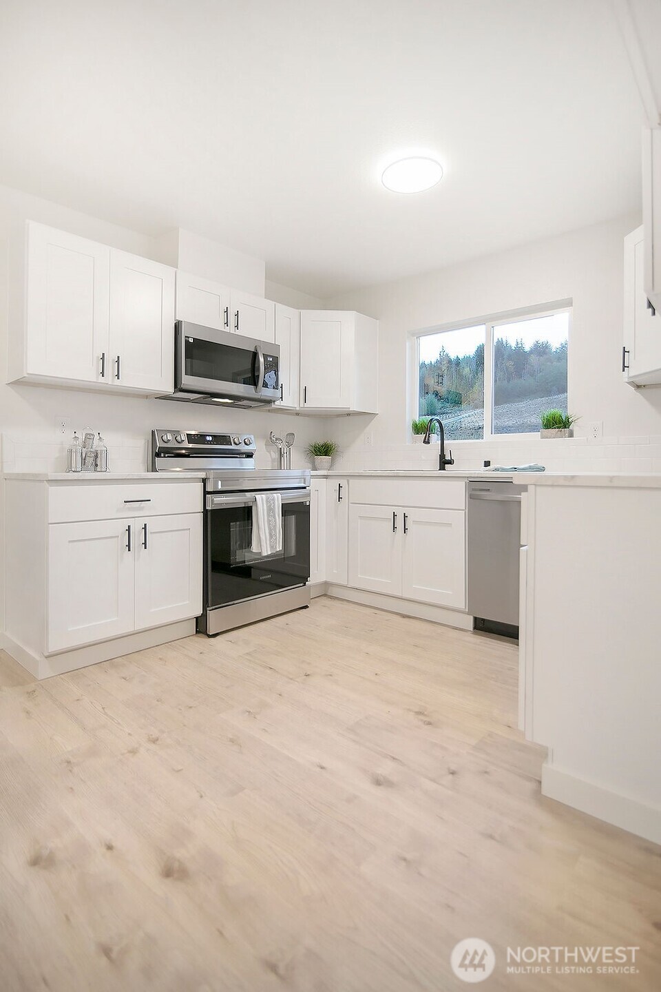 251 Swofford Road Mossyrock, WA 98564 - Photo 10 of 38 a large white kitchen with stainless steel appliances granite countertop a stove and a sink
