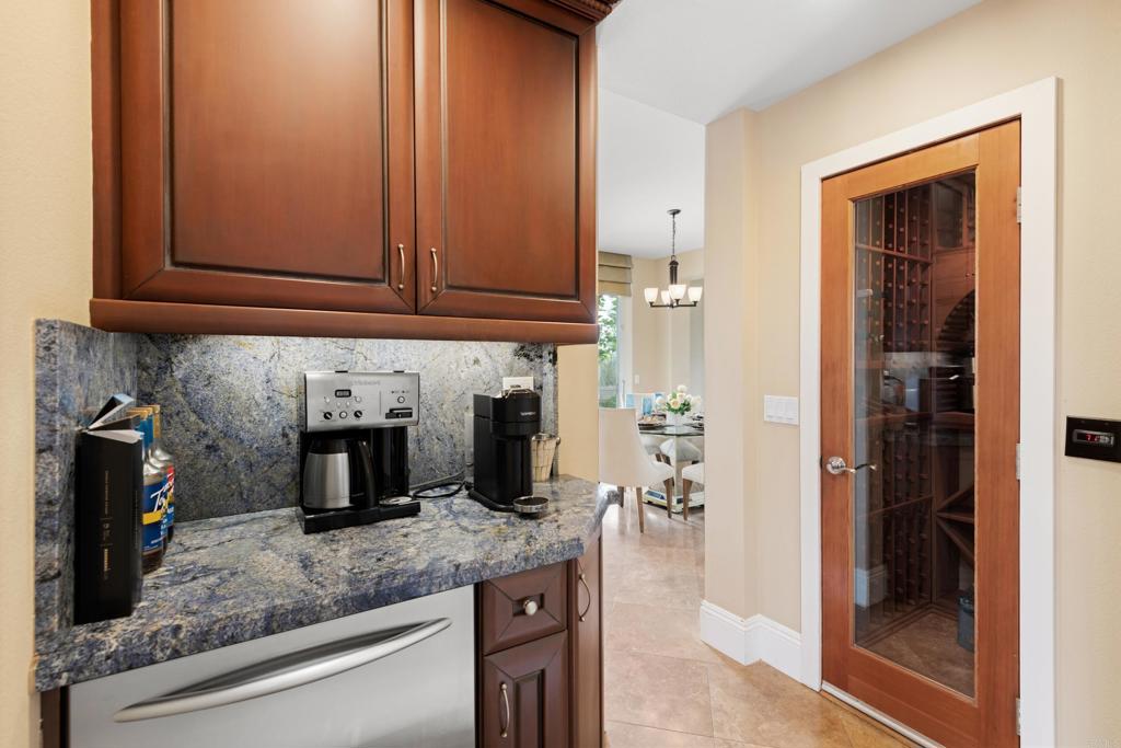 2541 Muirfields Drive Carlsbad, CA 92009 - Photo 11 of 58 a kitchen with granite countertop a sink and cabinets