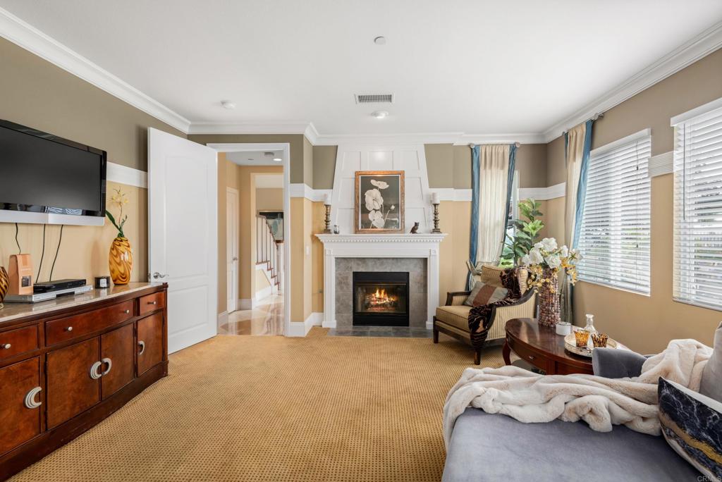 2541 Muirfields Drive Carlsbad, CA 92009 - Photo 21 of 58 a living room with furniture and a fireplace