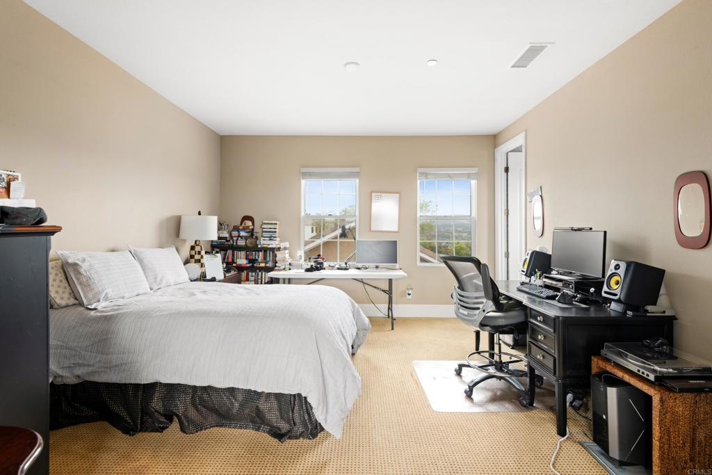 2541 Muirfields Drive Carlsbad, CA 92009 - Photo 27 of 58 a living room with furniture a flat screen tv and a window