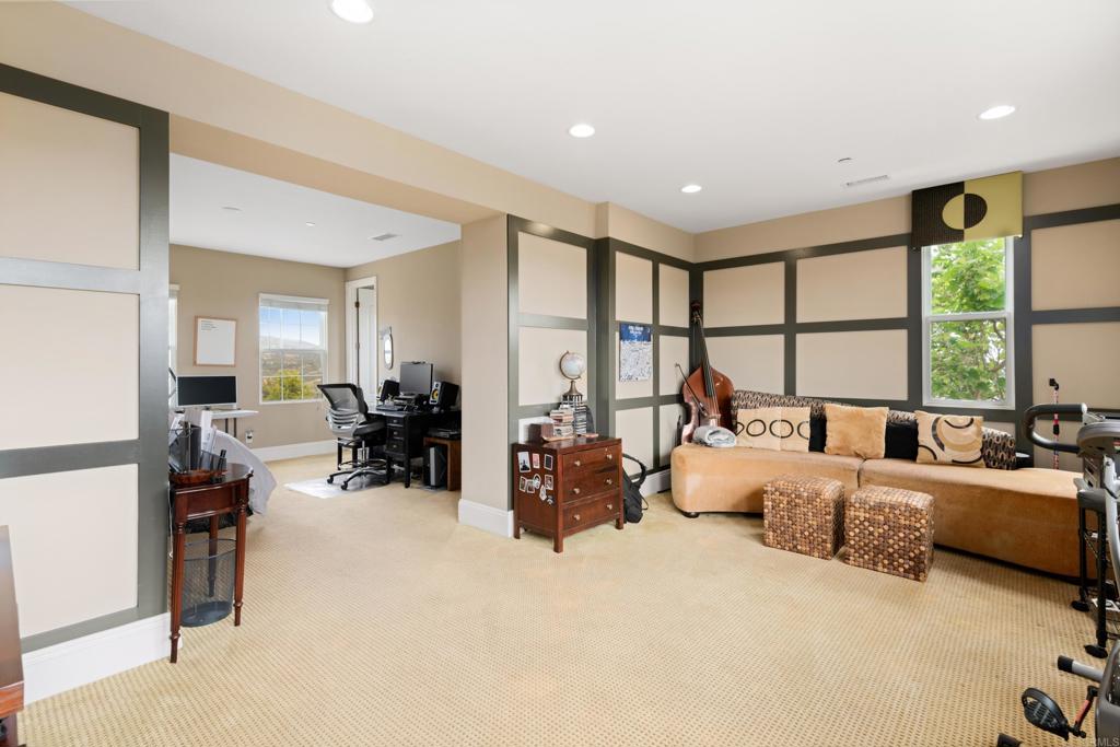 2541 Muirfields Drive Carlsbad, CA 92009 - Photo 29 of 58 a large room with bed couches chair and a large window