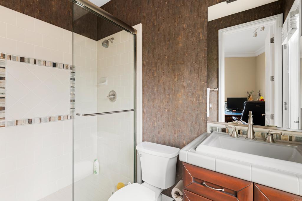 2541 Muirfields Drive Carlsbad, CA 92009 - Photo 38 of 58 a bathroom with a sink toilet vanity and shower