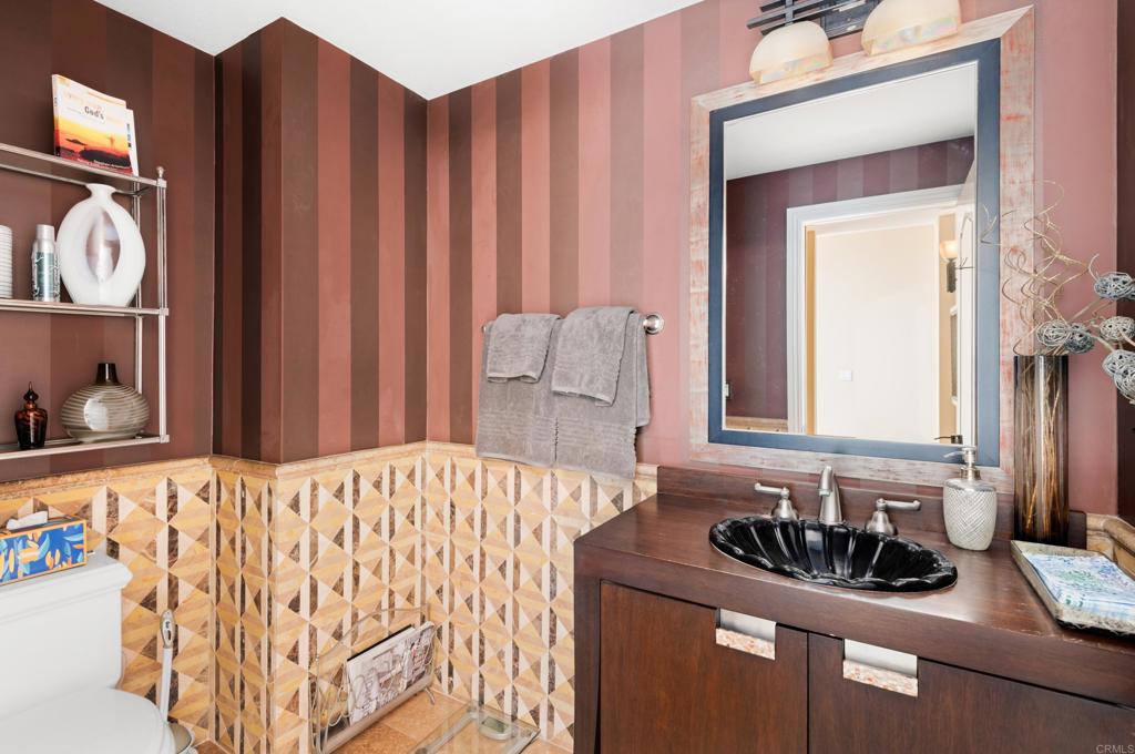 2541 Muirfields Drive Carlsbad, CA 92009 - Photo 6 of 58 a bathroom with a sink and a mirror