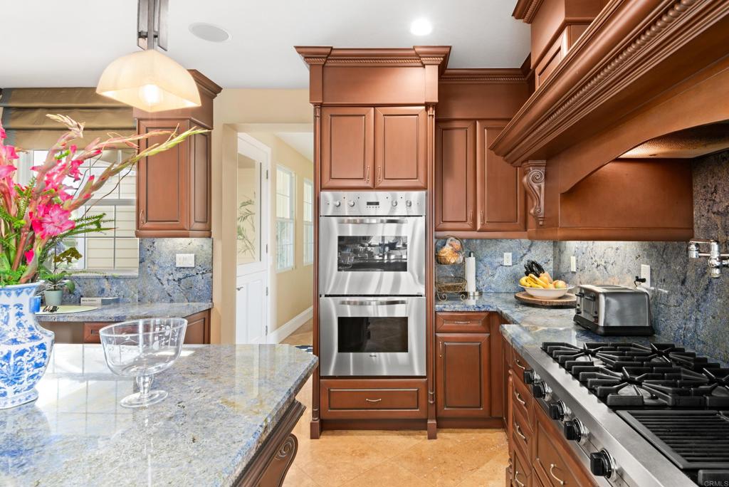 2541 Muirfields Drive Carlsbad, CA 92009 - Photo 8 of 58 a kitchen with stainless steel appliances granite countertop a stove a sink and a refrigerator