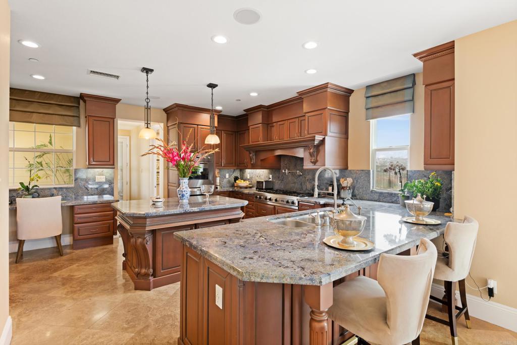 2541 Muirfields Drive Carlsbad, CA 92009 - Photo 9 of 58 a kitchen with sink table and chairs