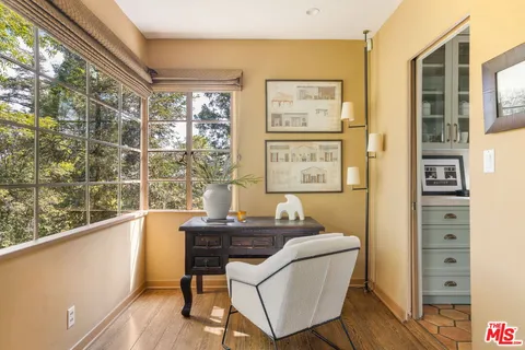 a dining room with furniture and wooden floor
