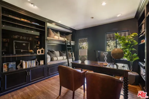 a living room with furniture and a bookshelf