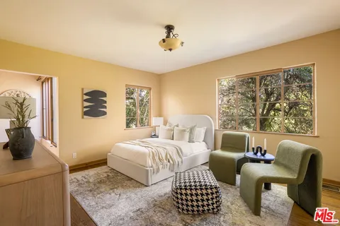 a bedroom with a bed and a couch