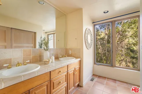 a spacious bathroom with a granite countertop sink and a mirror
