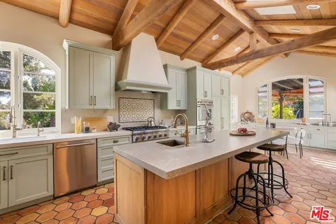 a kitchen with a stove a sink dishwasher and a refrigerator