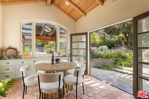 a dining room with a large window and table