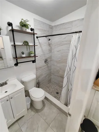 a bathroom with a toilet and a shower
