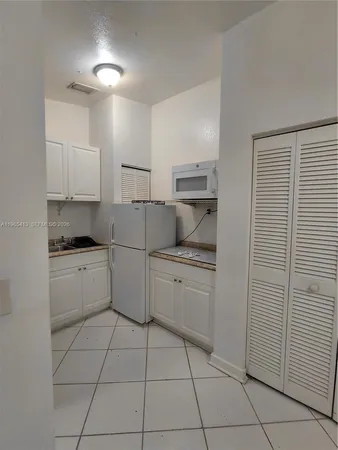 a kitchen with a cabinets and appliances
