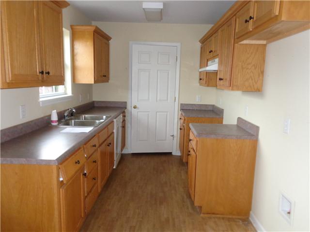 6142 Owens Chapel Road Springfield, TN 37172 - Photo 7 of 16 a kitchen with stainless steel appliances granite countertop a sink stove and refrigerator