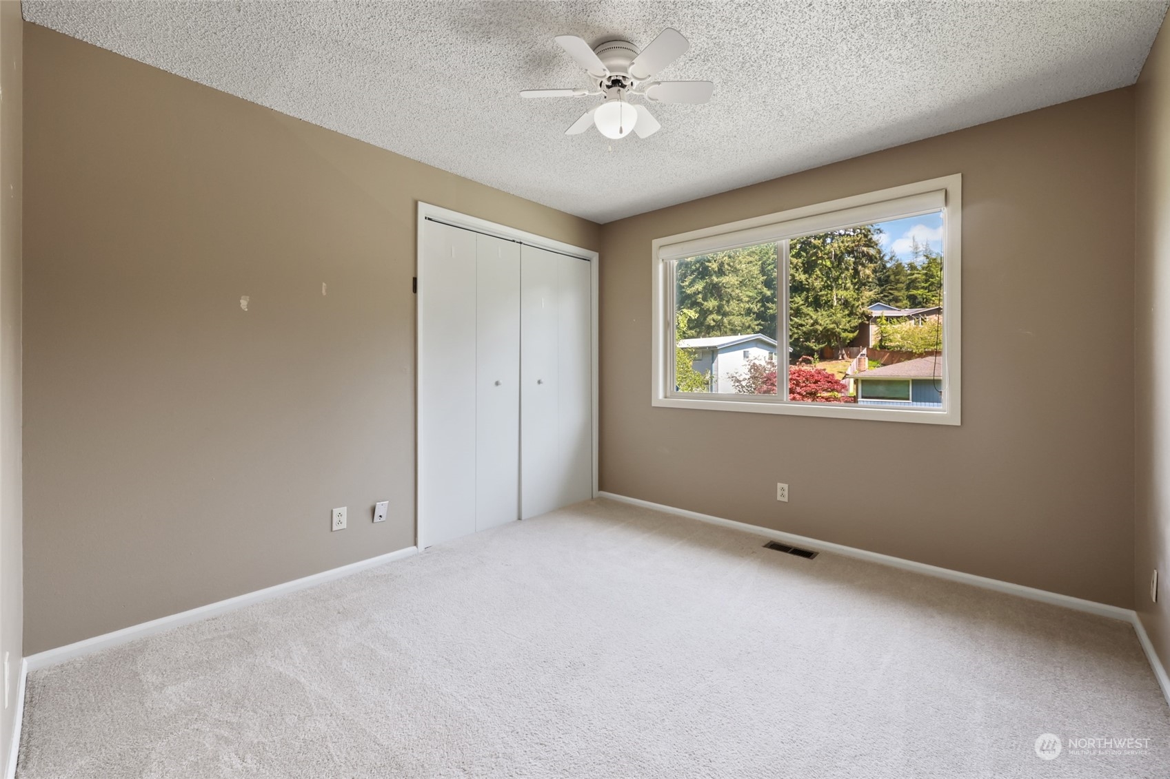 13835 17th Avenue Southwest Burien, WA 98166 - Photo 11 of 33 an empty room with windows and ceiling fan