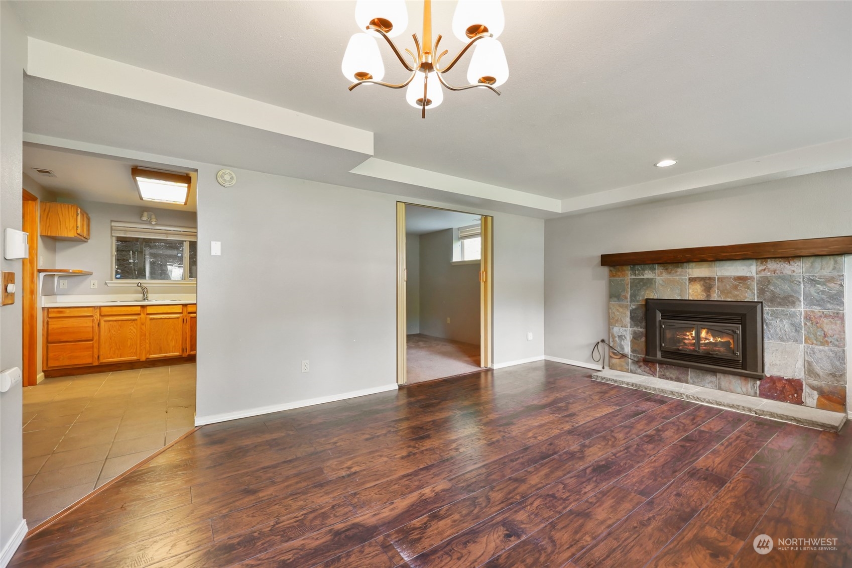 13835 17th Avenue Southwest Burien, WA 98166 - Photo 26 of 33 a view of a livingroom with a fireplace and a chandelier