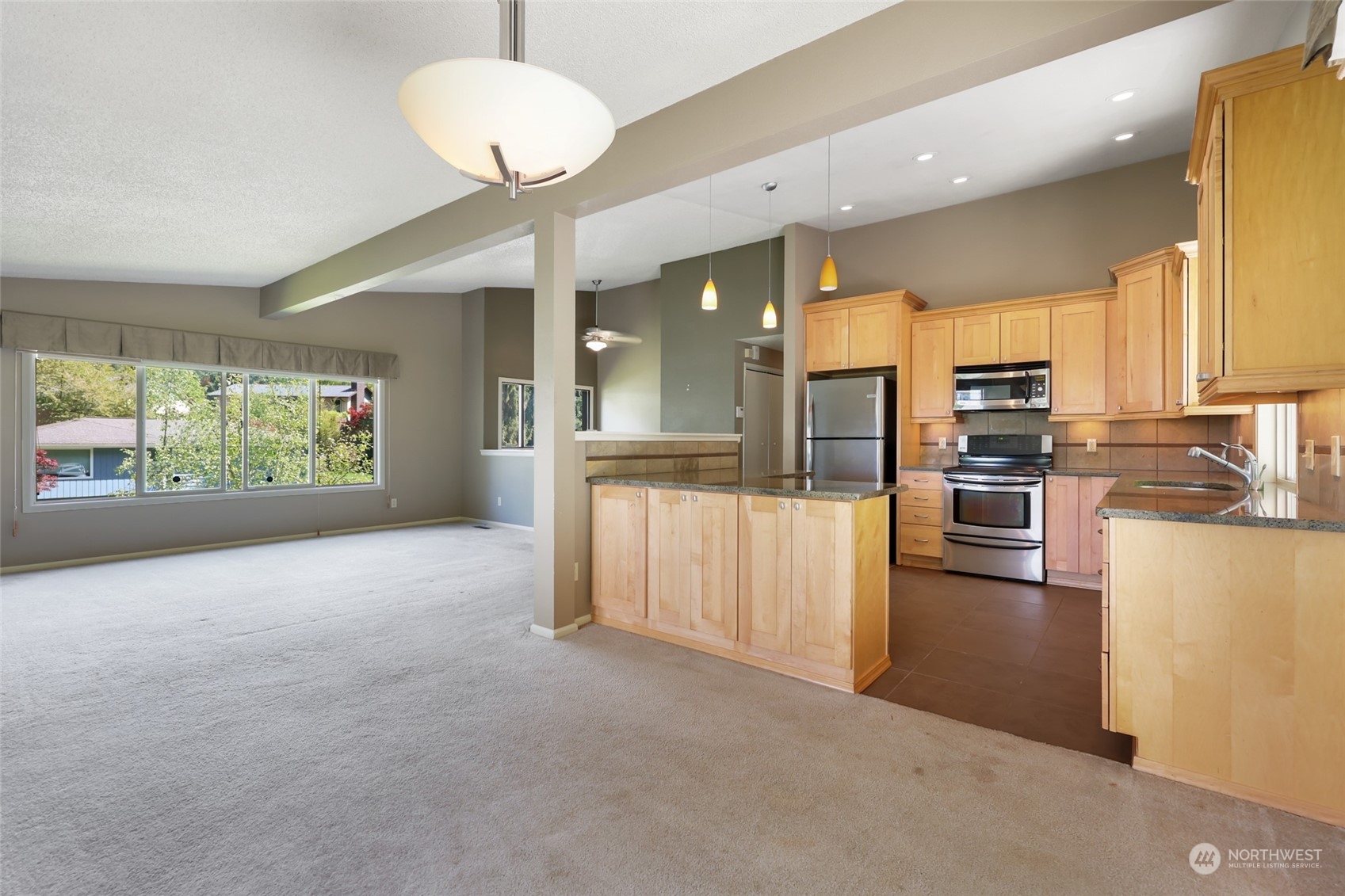 13835 17th Avenue Southwest Burien, WA 98166 - Photo 7 of 33 a view of a kitchen with kitchen island and stainless steel appliances