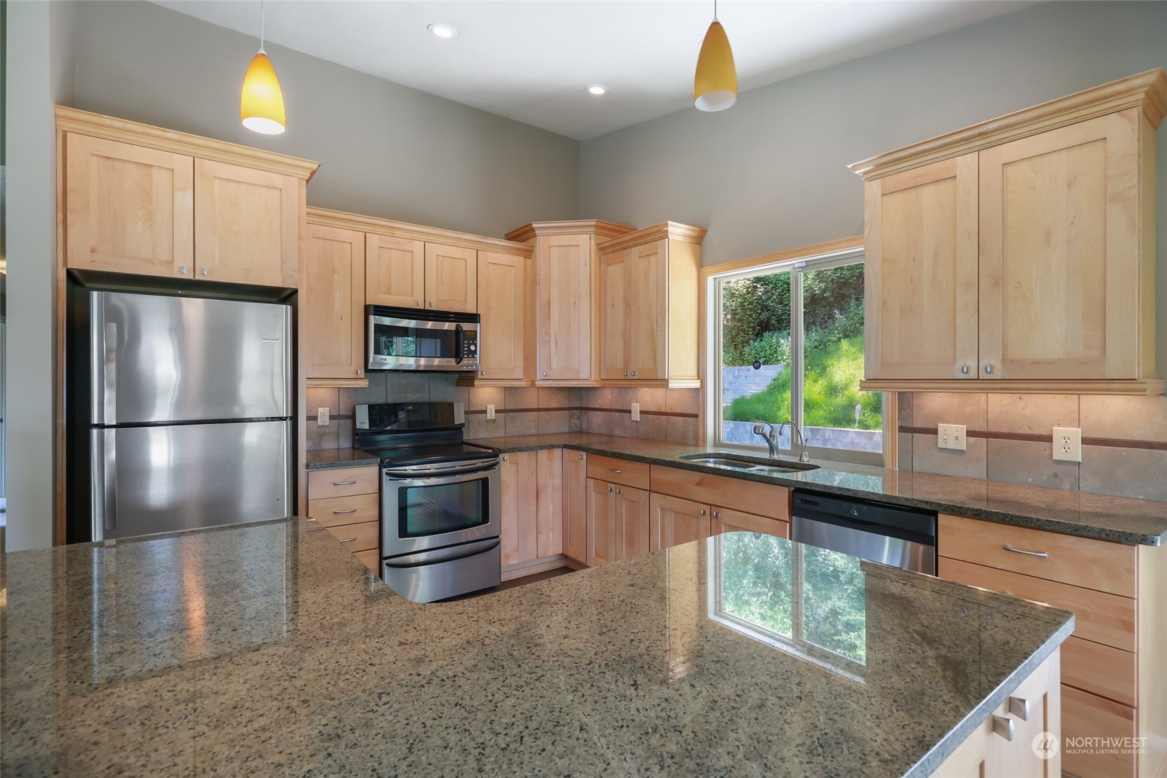 13835 17th Avenue Southwest Burien, WA 98166 - Photo 8 of 33 a kitchen with kitchen island granite countertop a stove a sink and a refrigerator