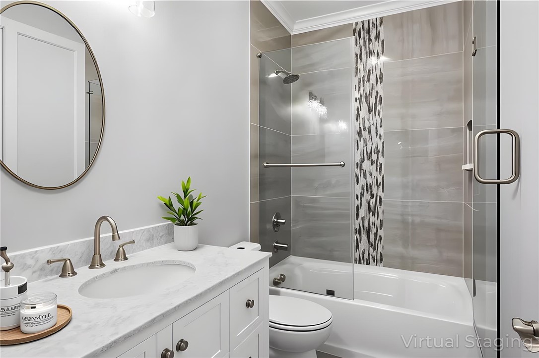 303 Regency Circle Anderson, SC 29625 - Photo 38 of 50 This bathroom features a sleek vanity with a classic round mirror and a beautifully tiled shower.