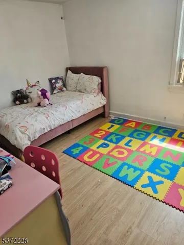 a bedroom with two beds and a lamp