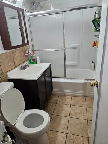 a bathroom with a sink mirror vanity and toilet