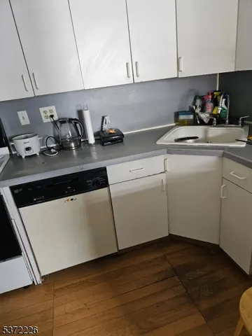 a kitchen with a sink a stove and cabinets