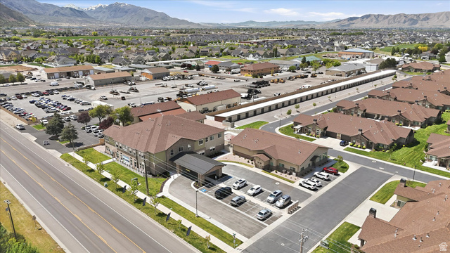 1838 West 300th Street South, Unit B Mapleton, UT 84664 - Photo 44 of 51 Aerial perspective showcasing a multi-story building, surface parking, and a covered drop-off area