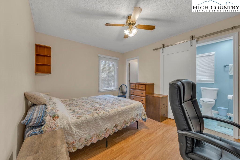 6 Ridgewood Lane Newland, NC 28657 - Photo 19 of 45 a bedroom with a bed a desk and chair