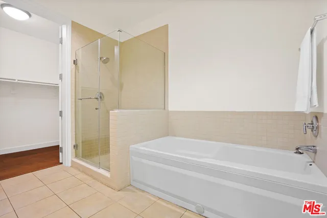 a spacious bathroom with a bathtub and a shower
