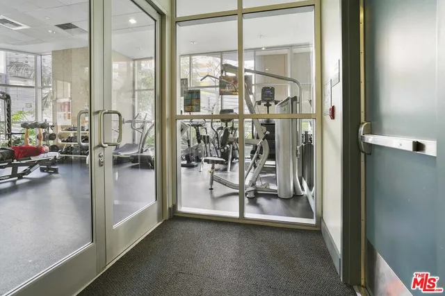 a view of a livingroom with couch and floor to ceiling window
