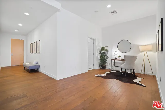 a view of a room with a table and a lamp