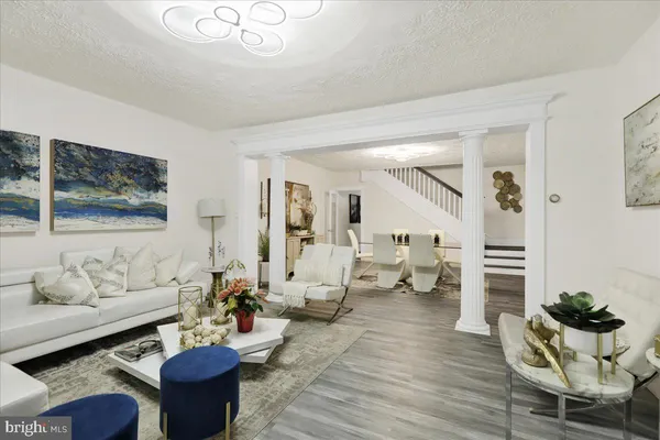 a living room with furniture and wooden floor
