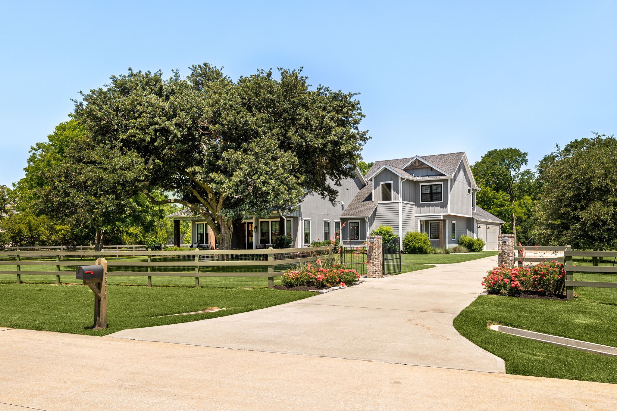 4311 Upper Oxbow Trace Fulshear, TX 77441 - Photo 5 of 49 Stunning modern farmhouse exterior with manicured landscaping, oversized driveway, and timeless curb appeal.