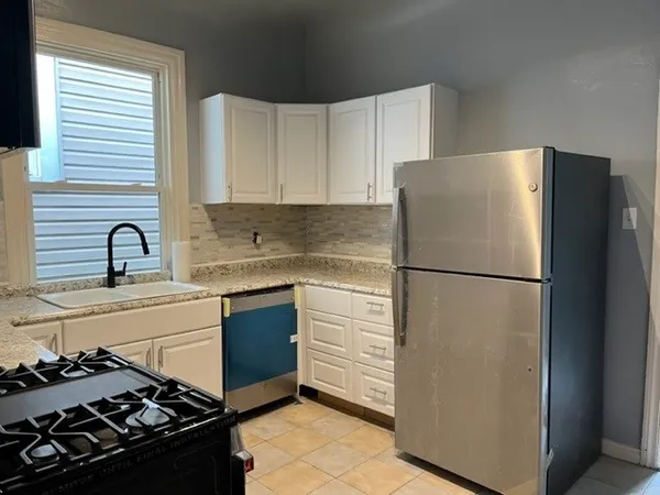 a kitchen with a refrigerator stove and sink