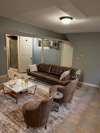 a living room with furniture and wooden floor