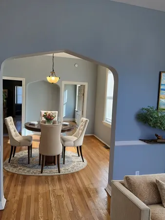 a view of a dining room with furniture and wooden floor
