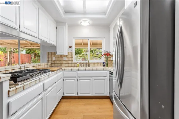 a kitchen with a sink stove and cabinets