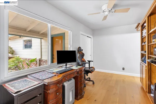 a living room with a bed furniture and a window